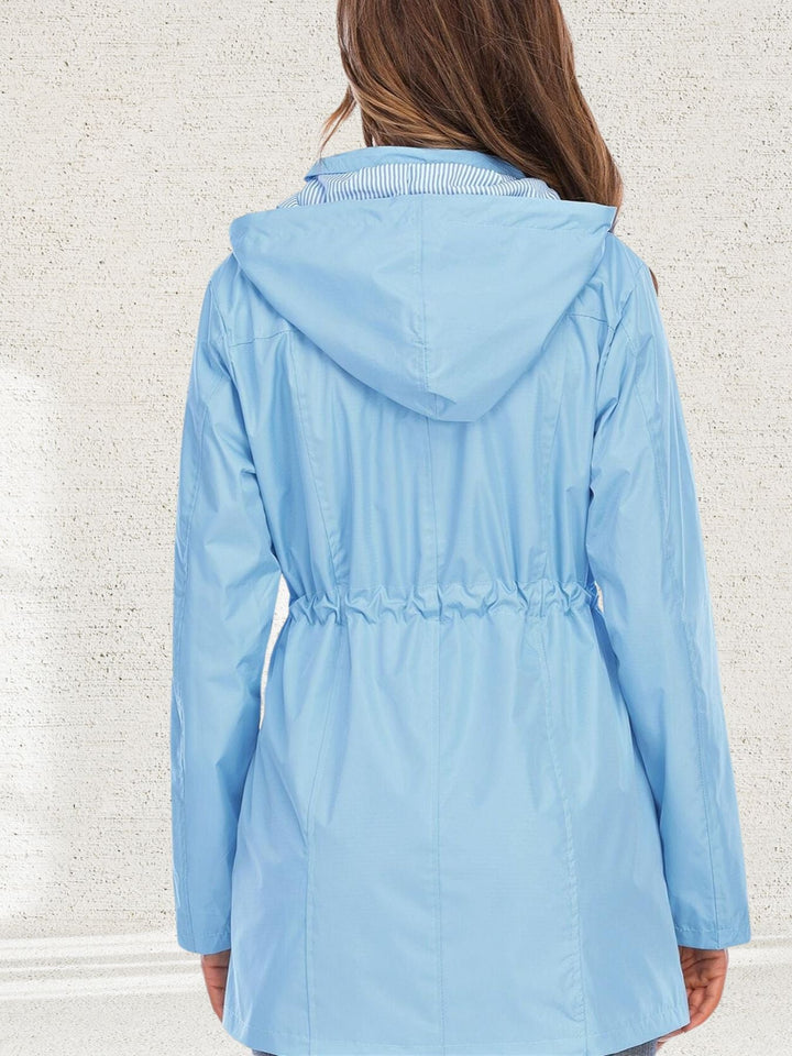 Freya light blue rain jacket back view with striped hood lining
