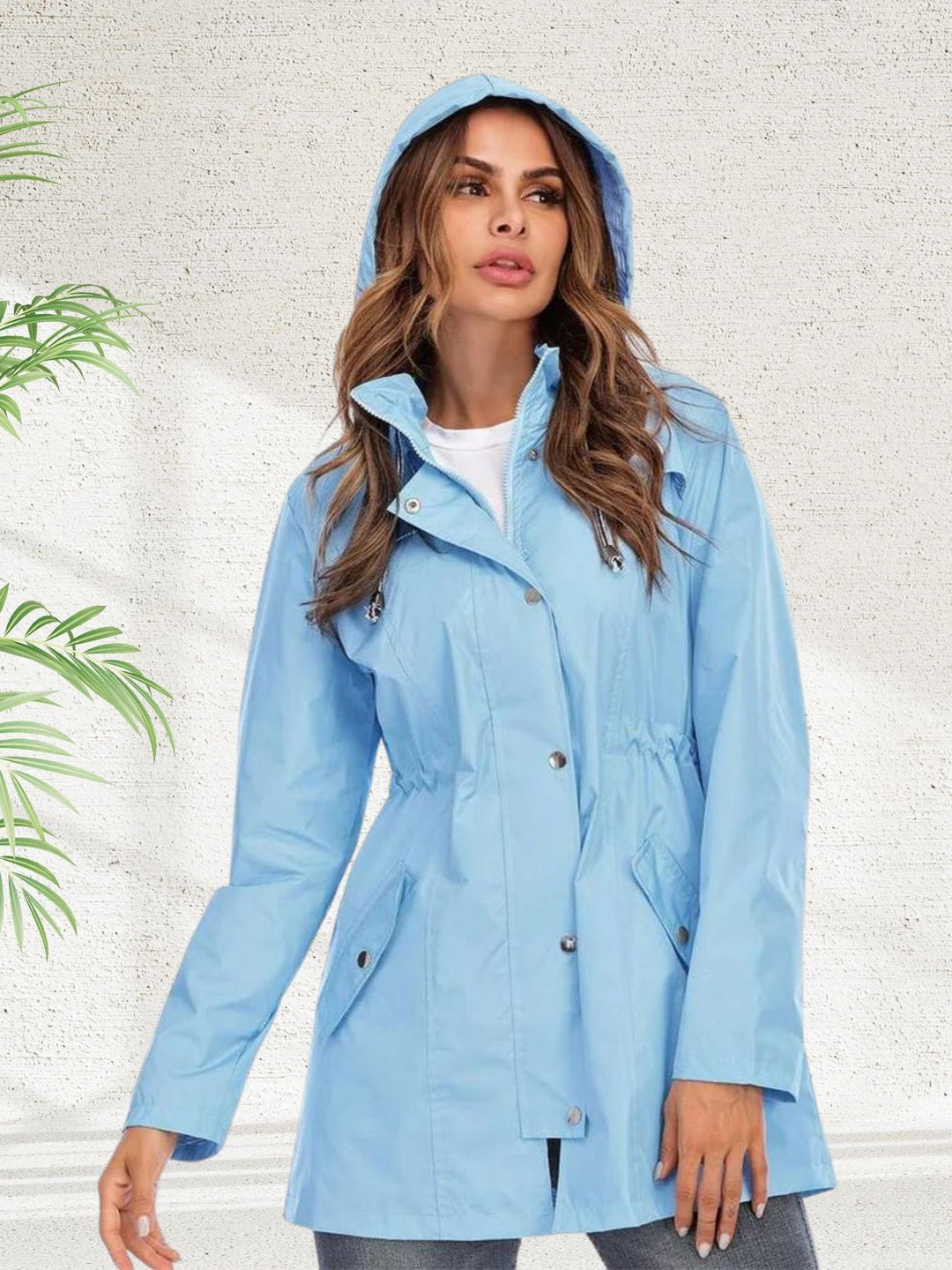 Freya light blue rain jacket with hood up, side profile