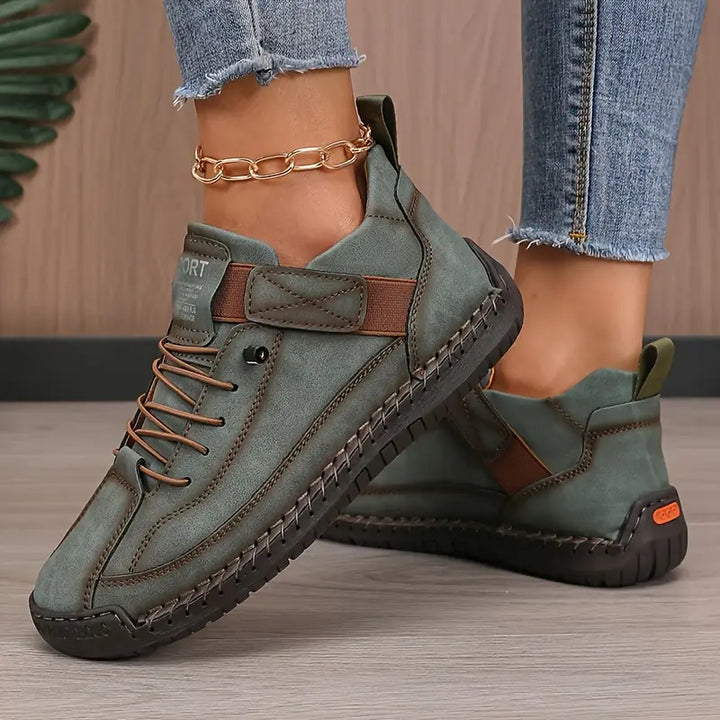 Hollis sneakers in green, pair shown on flooring