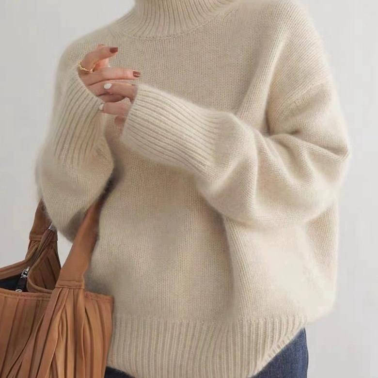 Marigold turtleneck jumper in cream, side view with tote bag