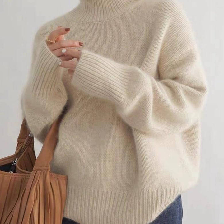 Marigold turtleneck jumper in cream, side view with tote bag