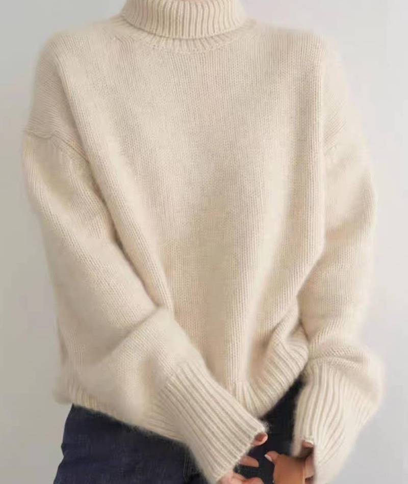 Marigold turtleneck jumper in cream, side view with tote bag