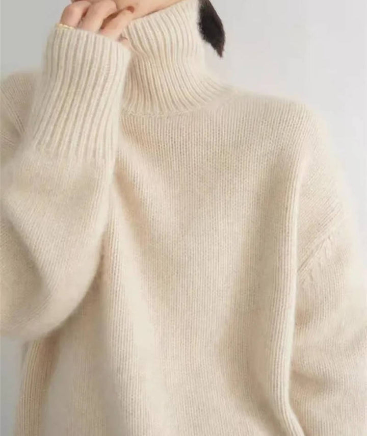 Marigold turtleneck jumper in cream, side view with tote bag