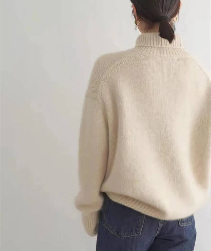 Marigold turtleneck jumper in cream, side view with tote bag