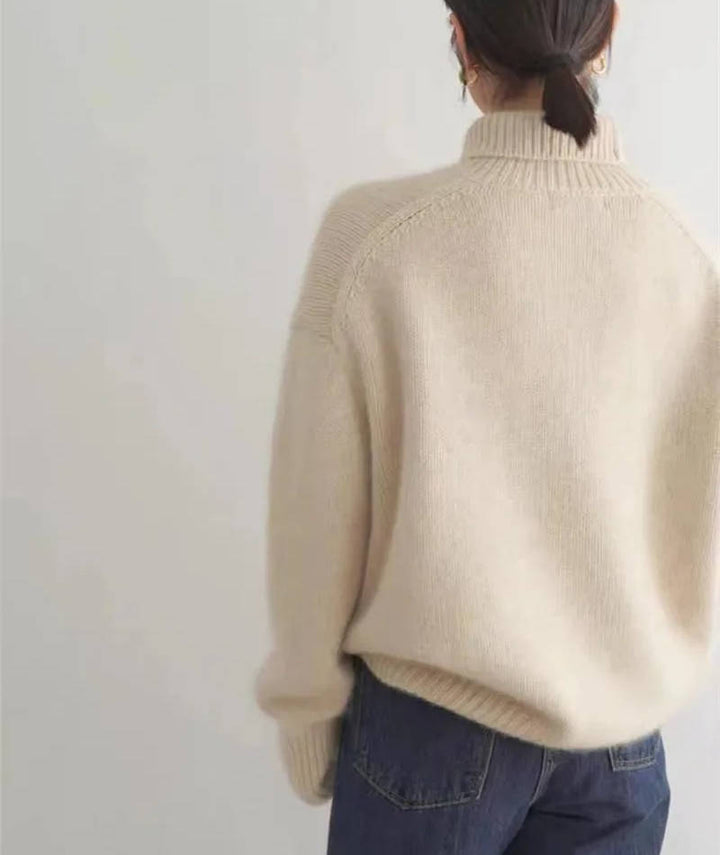 Marigold turtleneck jumper in cream, side view with tote bag