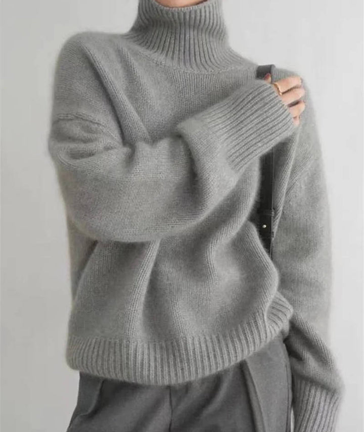 Marigold turtleneck jumper in cream, side view with tote bag
