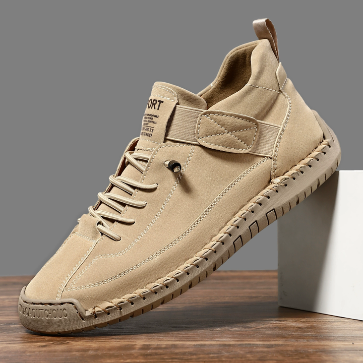 Clementine green orthopaedic sneakers with hand-stitched detail, pair on floor
