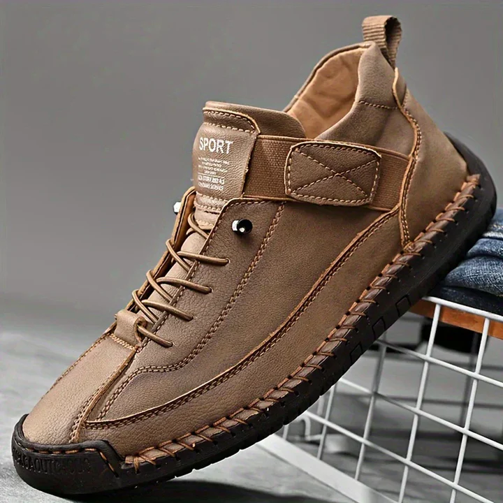 Clementine green orthopaedic sneakers with hand-stitched detail, pair on floor