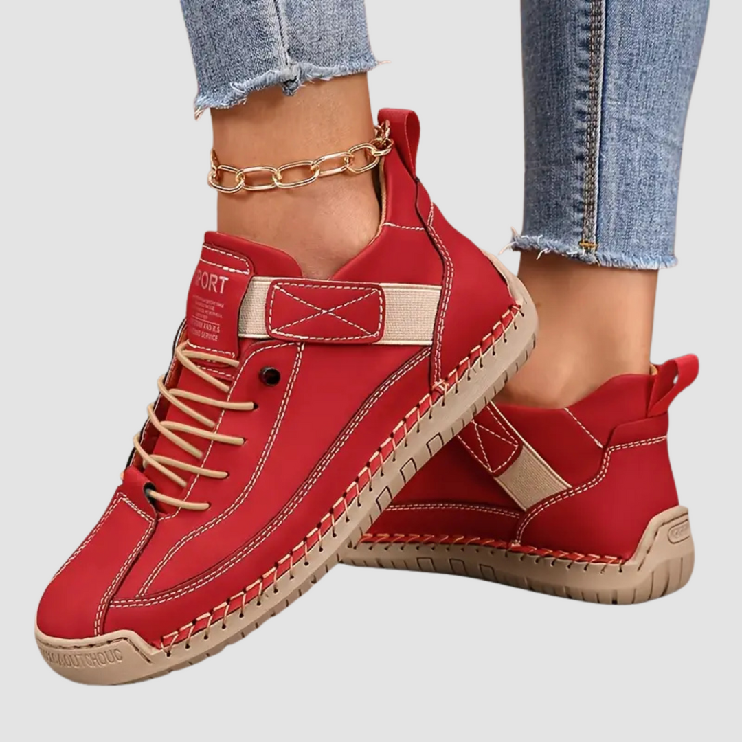 Clementine green orthopaedic sneakers with hand-stitched detail, pair on floor