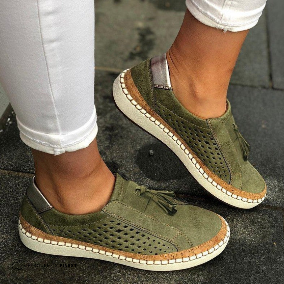 Matilda green perforated slip-on shoes worn on feet, side view
