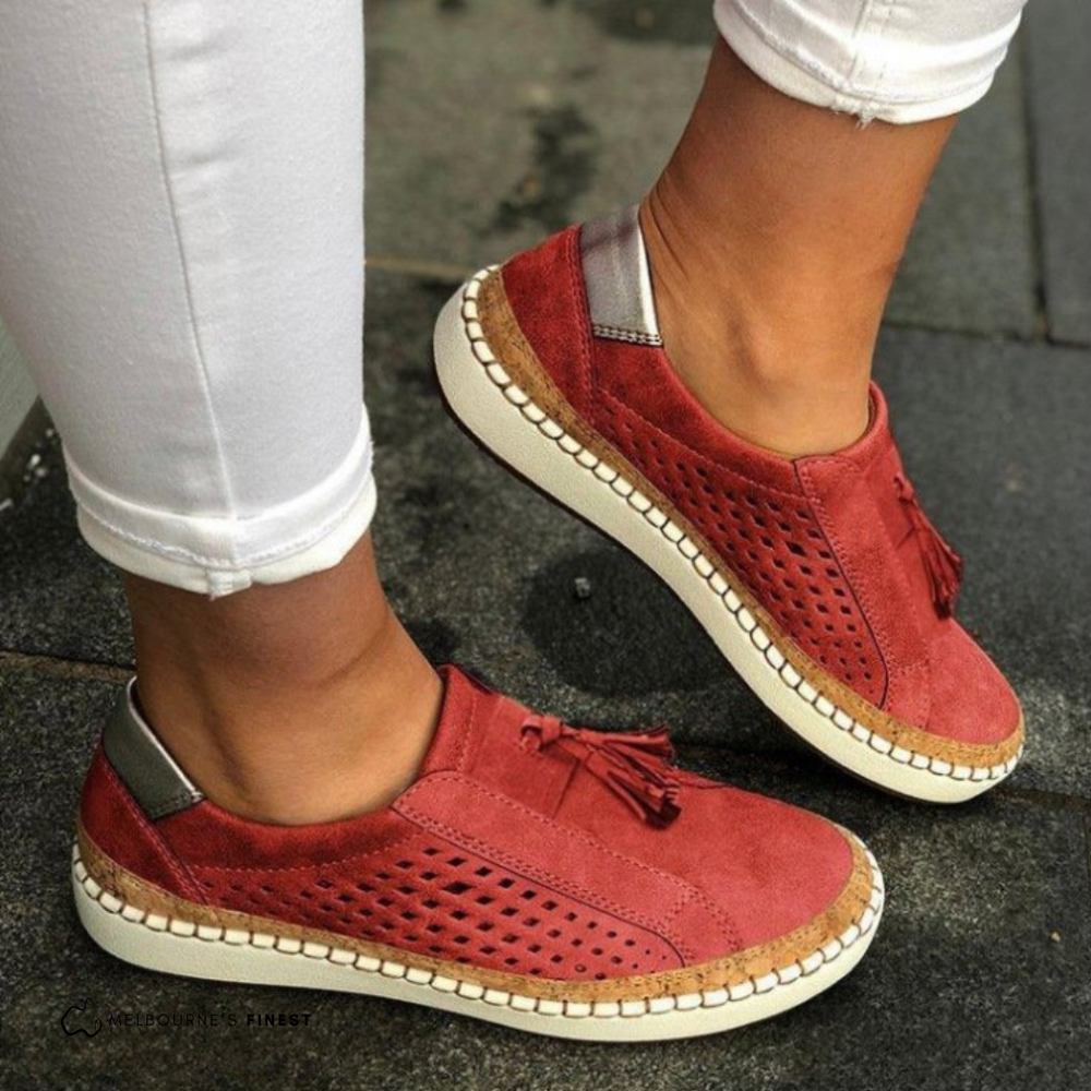 Matilda red perforated slip-on shoes worn on feet, side view
