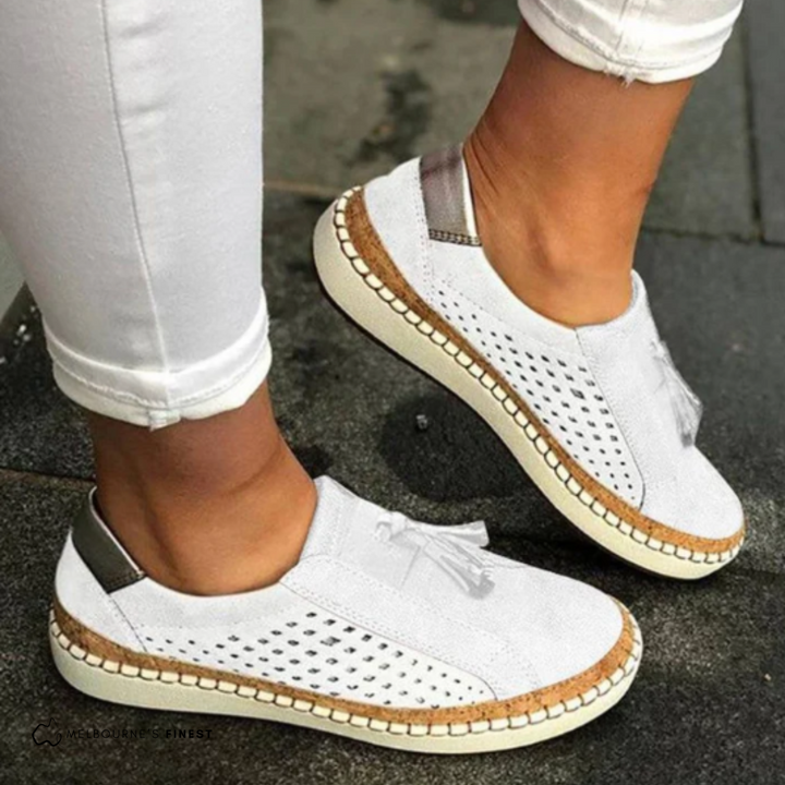 Matilda white perforated slip-on shoes worn on feet, side view