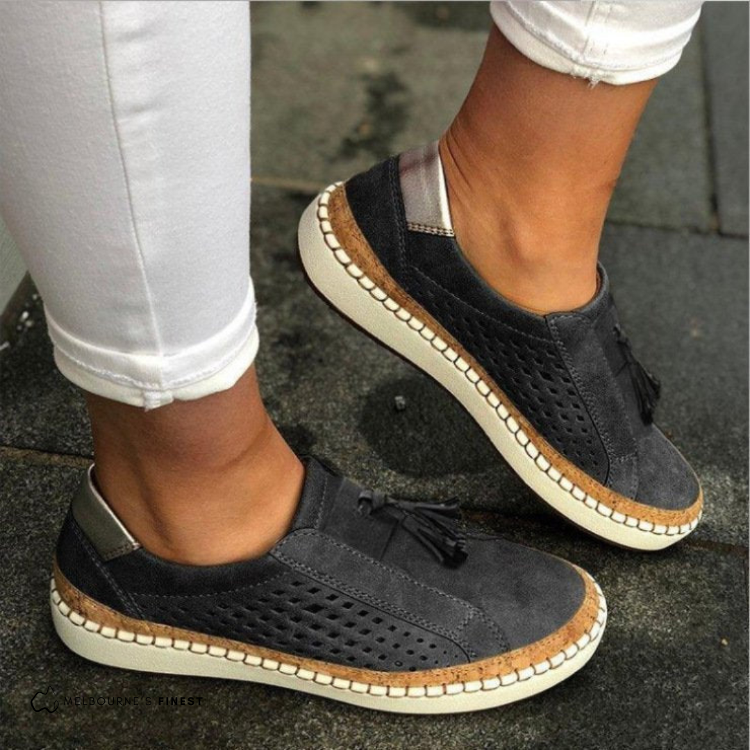 Matilda blue perforated slip-on shoes worn on feet, side view