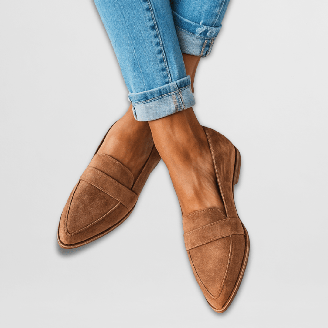 Rosalind suede penny loafers in tan, worn with cuffed jeans, crossed ankles
