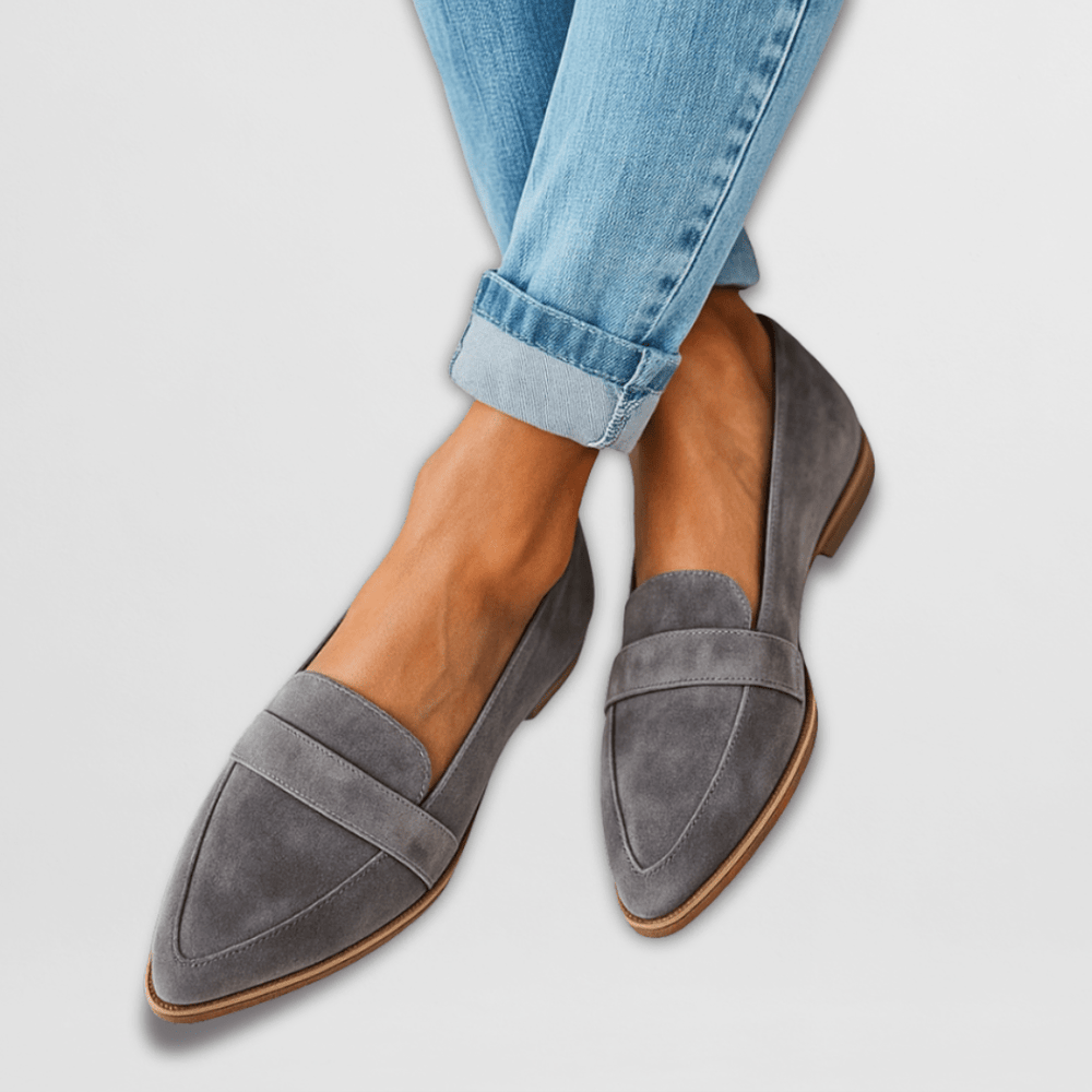 Rosalind suede penny loafers in grey, worn with cuffed jeans, front view