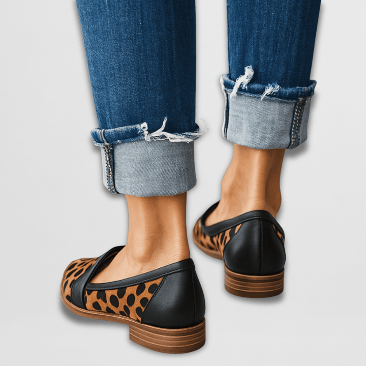 Rosalind suede penny loafers in leopard print, worn with cuffed jeans, front view